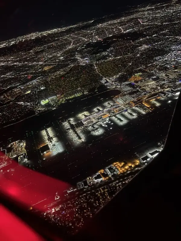 City lights and airport terminals at night from the air