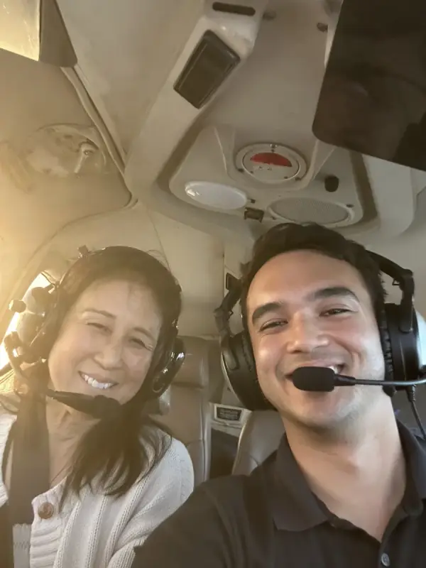 Chadd Alef and a student smiling in the cockpit